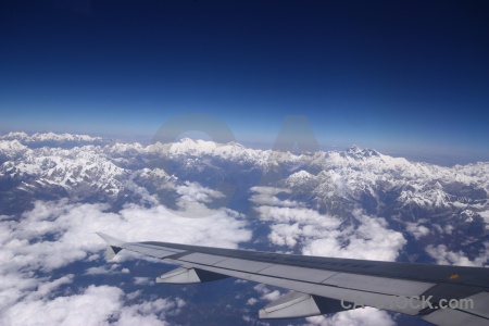 Airplane sky wing snowcap everest.