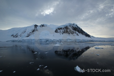 Antarctica channel reflection sea snowcap.