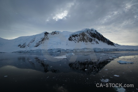 Antarctica mountain sea ice cloud snow.