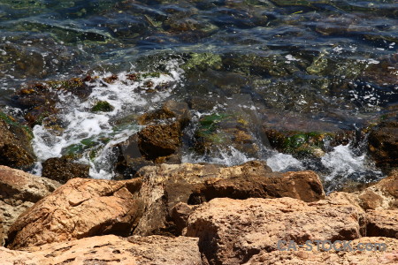 Brown rock sea coast water.