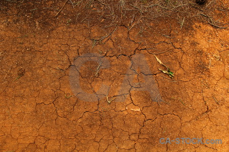 Crack soil orange brown texture.