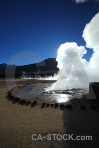 Geyser water pool sun atacama desert.