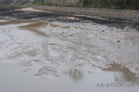 Gray mud sea water beach.