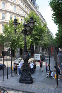 Lamp post green person white.