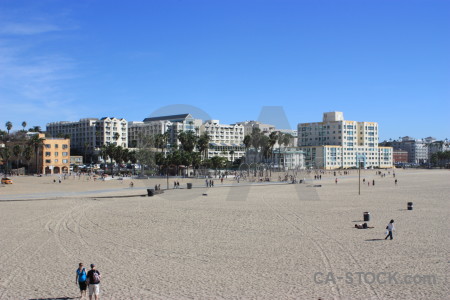 Person blue building cityscape beach.