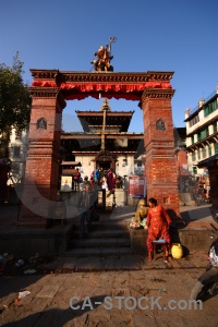 Person building wood south asia temple.