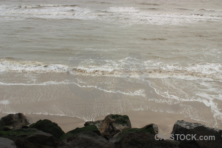 Rock coast gray sea water.