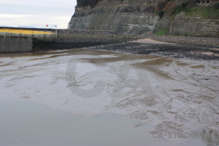 Sea gray beach water mud.