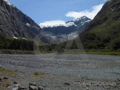Stone cloud tree snowcap new zealand.
