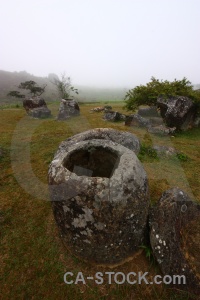 Tree rock asia plain of jars sky.