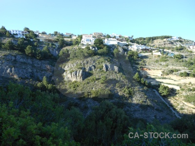 Tree sky cliff javea building.