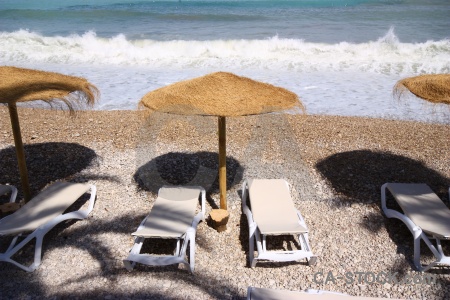 Umbrella stone sea water shadow.