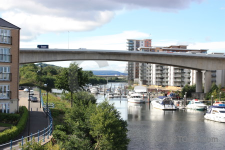 Vehicle bridge cityscape boat river.