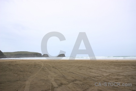 Wave catlins sky sand sea.