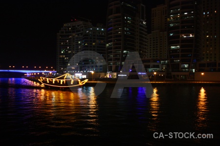 Western asia skyscraper boat night water.